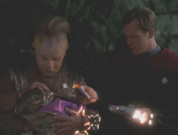Neelix and Tom caring for the baby alien