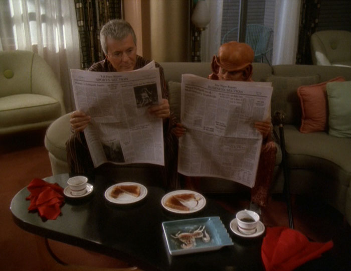 Vic and Nog reading the paper together