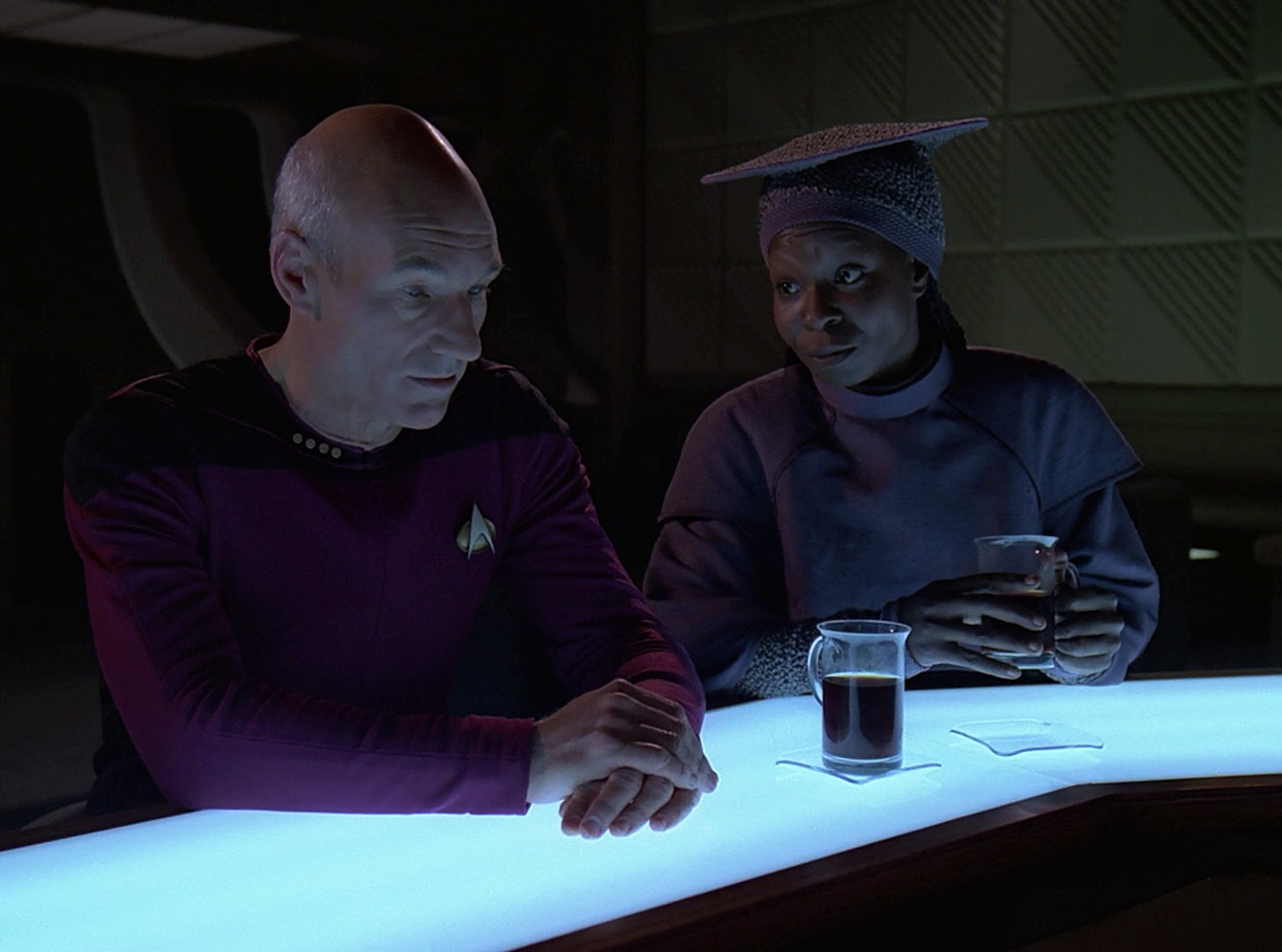 Picard and Guinan talking at the bar